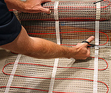 To turn the mat at the end of a row, cut the mesh backing and make the turn.