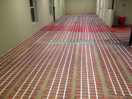 Radiant floor heating system being installed. ComfortTile floor heating mats installed for heated floor.